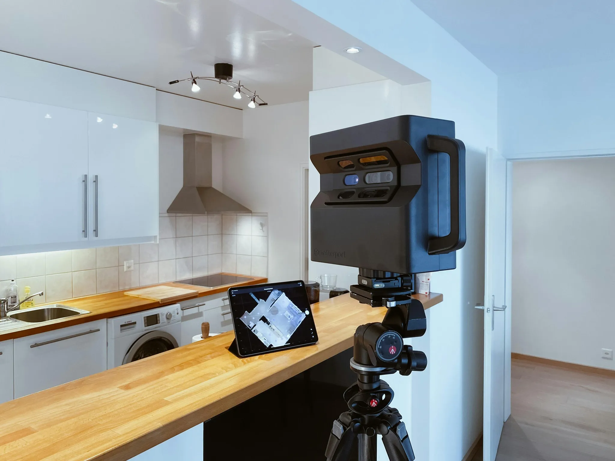 A Matterport Pro2 camera on a tripod, scanning a kitchen